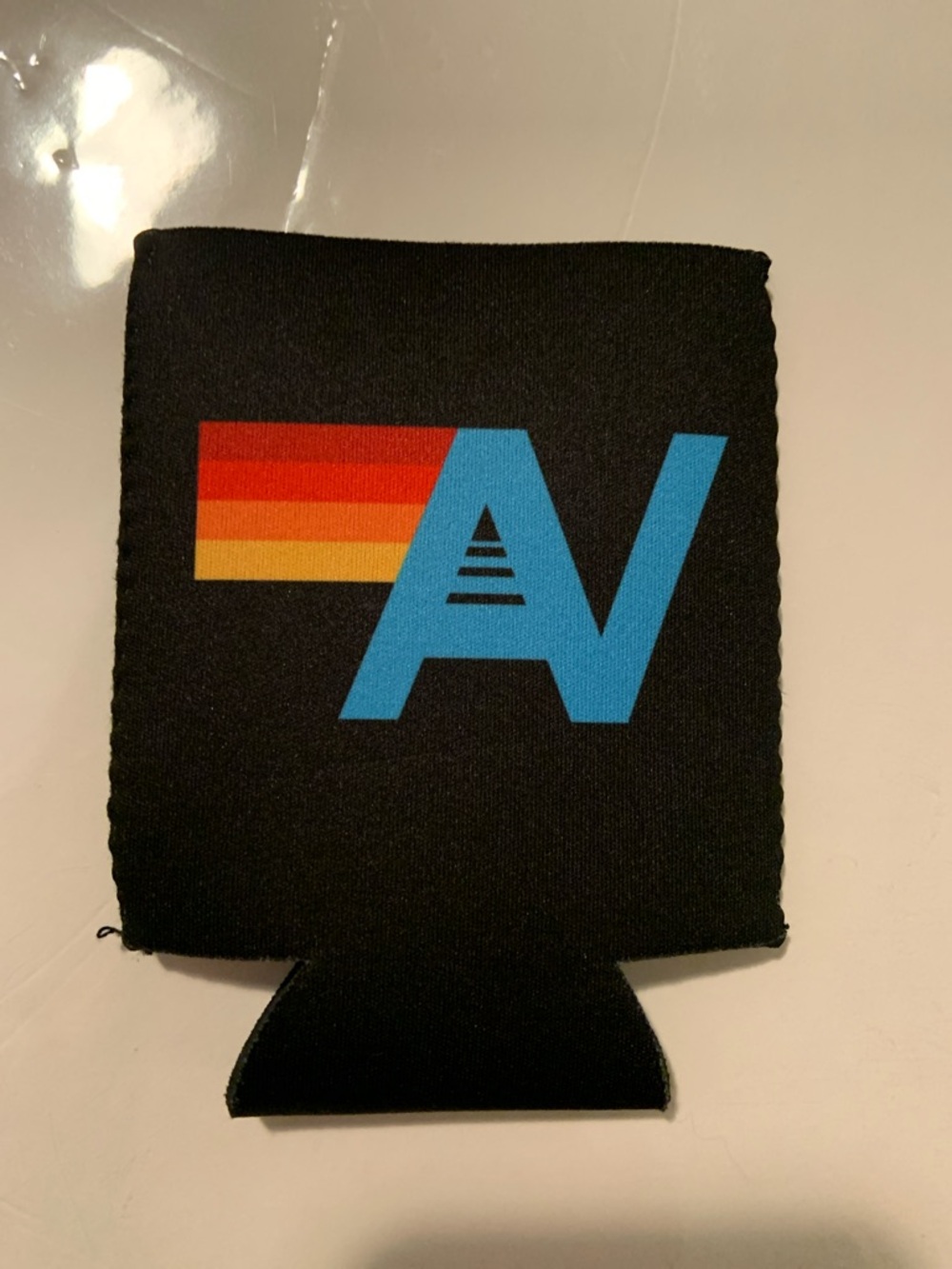 Black Can Cooler with Blue 'AV' Logo and Retro Stripe